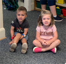 A boy and girls waiting for circle time to begin in the Busy Bees classroom at Stepping Stones Child Care